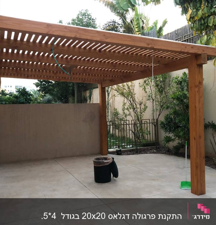 פרגולה מעץ בחצר עם רצפת בטון